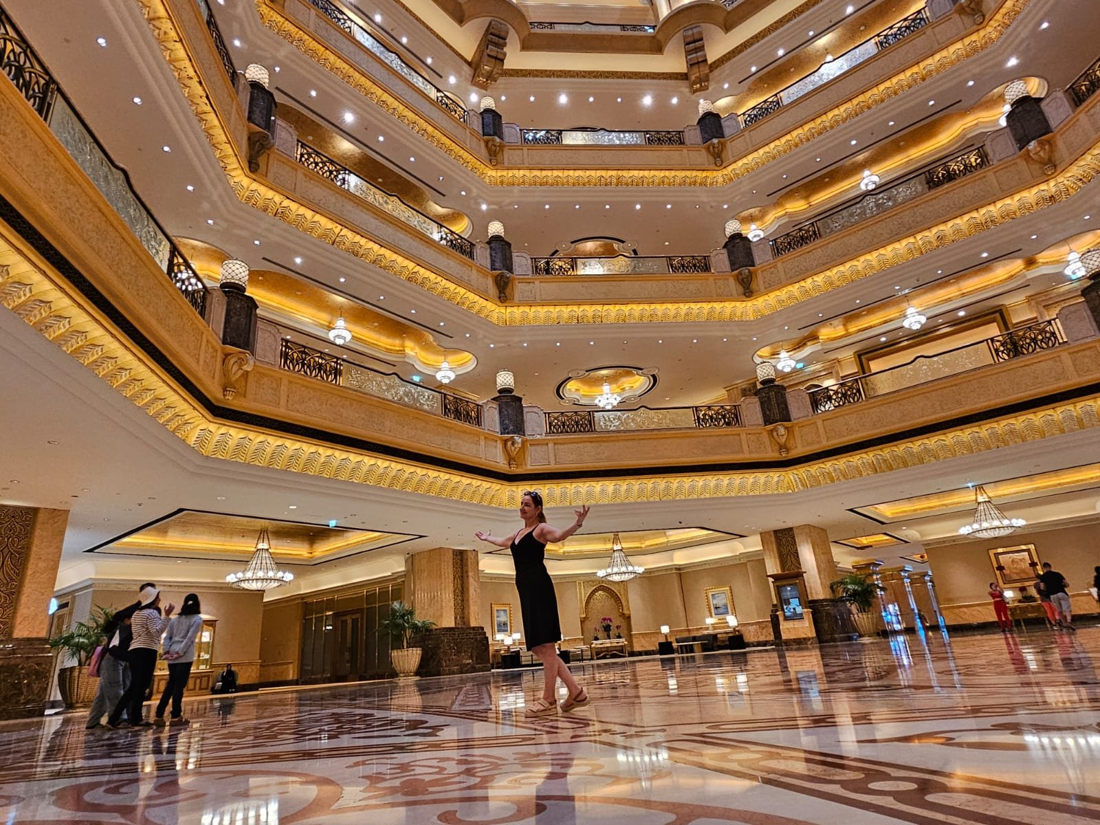 A woman posing inside the luxurious interior of Emirates Palace.